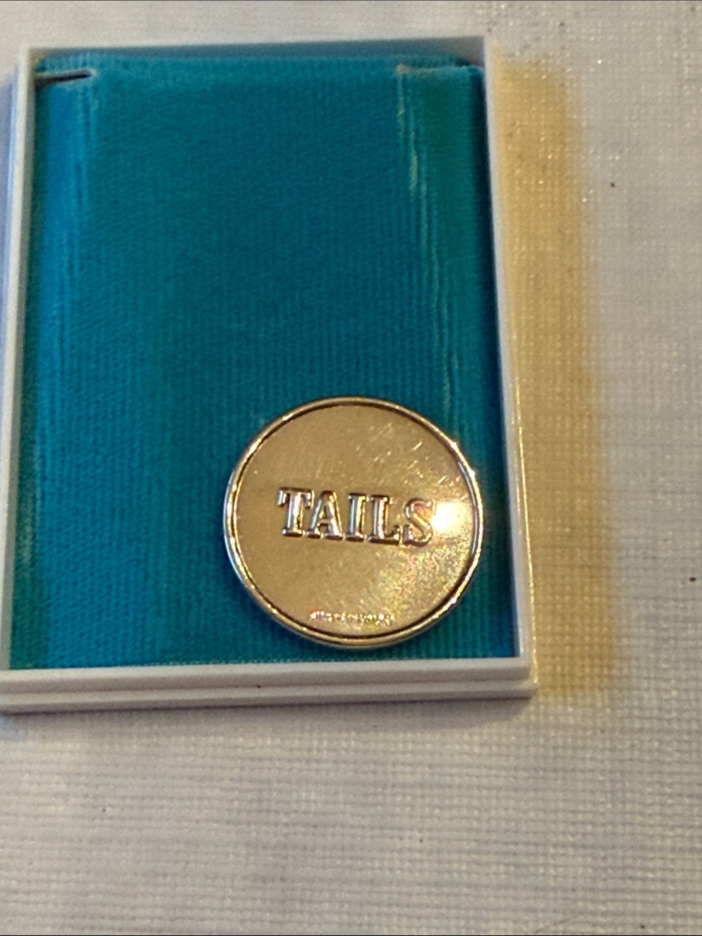 Tiffany & Co. sterling silver "Heads or Tails" flip coin.